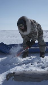 John Pingayak collects firewood on the frozen tundra. (National Geographic/Matt Kynoch)