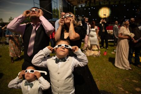 Clockwise from top right: Nicholas Blackwell, Katie Baucom, Cash Whitaker, and Izaiah Blackwell view the eclipse. The path of totality stretched from Texas to Maine. While only those in this path saw the moon completely cover the sun, a partial eclipse was still viewable for millions throughout the eastern U.S. (Credit: Aaron Huey)