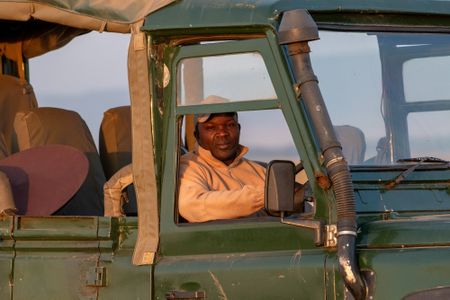 Spotter Driver Patrick Isaiga leads the crew toward a location where he believes Summer's Pride might be found. (National Geographic/Claire Arthur)