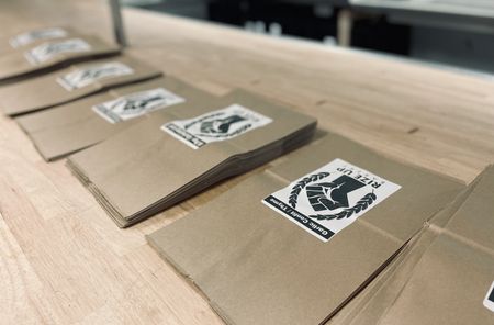 Branded bread bags are ready to be filled at Rize Up Bakery in San Francisco. For baker Z Anderson, the raised fist has many meanings; foremost among them is "power to the people." (National Geographic/Ryan Rothmaier)