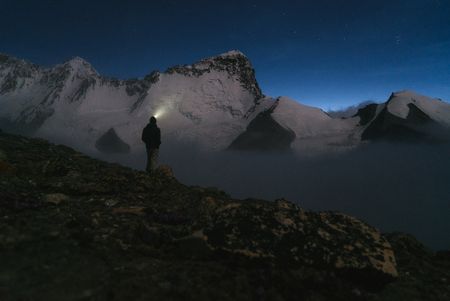 Conrad Anker looks up at Shishapangma as the sun slowly rises. (Credit: Max Lowe)
