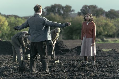 A SMALL LIGHT - Jan, played by Joe Cole, reacts to Miep, played by Bel Powley, in the scheißfeld, as seen in A SMALL LIGHT. (Credit: National Geographic for Disney/Dusan Martincek)