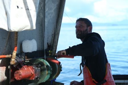 Matt Carlson fishes for salmon near the end of the summer troll season. (National Geographic/Wayne Moss)