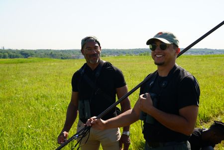 Christian Cooper helps researcher José R. Ramìrez-Garofalo set up a mist net to catch grasshopper sparrows and Savannah sparrows at Freshkills Park. (National Geographic/Troy Christopher)