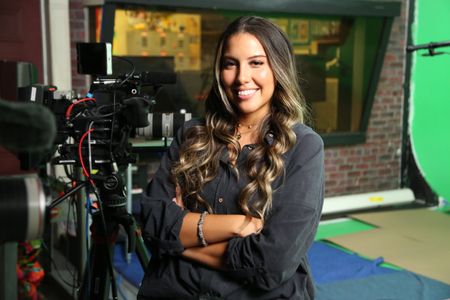 Heidy Martinez smiling with arms crossed next to video equipment. (National Geographic/Robert Toth)