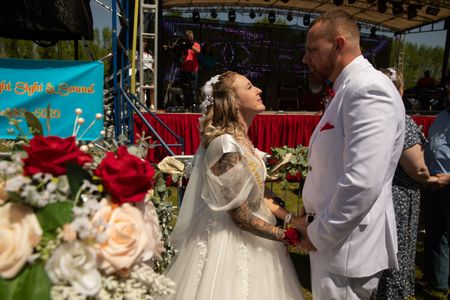 Michelle Weller and Randy Weller said their vows in front of the event's main stage. During a total solar eclipse, the moon covers the sun, leaving only a small ring of light called the corona. Participating couples noted the shape resembled a wedding band. (Credit: Aaron Huey)