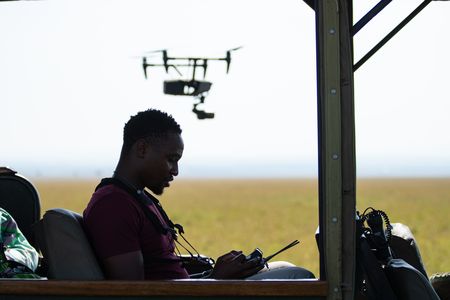 Anthony Njuguna operates his drone from the crew’s vehicle. (National Geographic/Hannah Gormley)