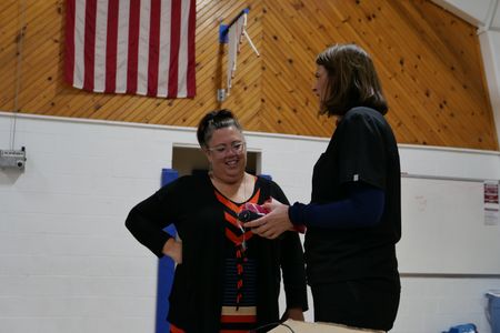 Dr. Erin Schroeder shows teacher Aja Jones some tools she brought to help with hair and makeup. (National Geographic)