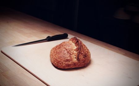 One of baker Z Anderson's sourdough loaves is ready to be sliced at his Rize Up bakery in San Francisco. (National Geographic/Ryan Rothmaier)