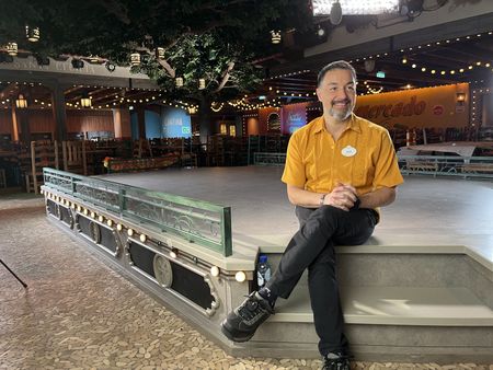 Show director Juan Cantú sits on stage in Plaza de Coco, the new entertainment restaurant on the Disney Treasure.  (credit: National Geographic/Jenn Brehm)