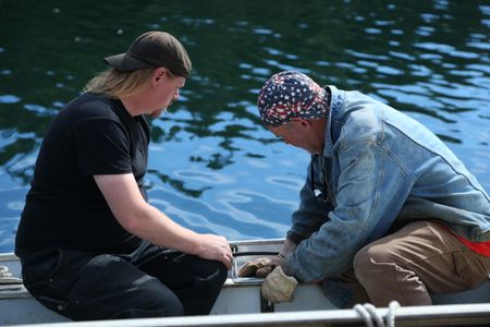 David Squibb and Sam Carlson install a newly constructed fairlead on Squibb's skiff. (National Geographic/Wayne Moss)