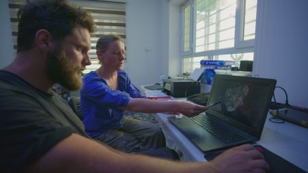 Ulrike Bergur and Jan Heiler examine the bone scans in Nineveh, Iraq. (Windfall Films)