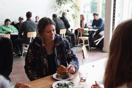 Baker Celine Underwood enjoys a slice at The Mill's weekly pizza party in San Francisco. (National Geographic/Ryan Rothmaier)