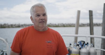 Michigan's State Maritime Archaeologist Wayne Lusardi sits for an interview in Port Huron, Mich. (National Geographic)