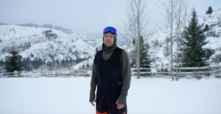 Big Mountain Snowboarder Travis Rice stands in the snow wearing his snowboarding gear.  (photo credit: National Geographic/Ross McDonnell)