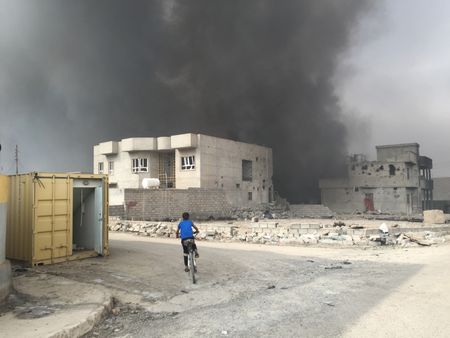 QAYARRAH, IRAQ - After leaving Qayarrah, ISIS sets oil fires as a parting gift for the villagers. (photo credit: Junger Quested Films LLC/Nick Quested)