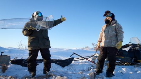 Gage and Avery Hoffman set blackfish traps below the ice to use as fishing bait. (BBC Studios/Danny Day)