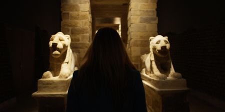 Kathleen Martinez walks towards  two lion statues. (credit:  National Geographic)