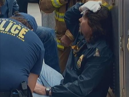 Luke Franey, who has just escaped through the rubble, is lead away from the scene at the Alfred P. Murrah Federal Building in Oklahoma City, Okla., April 19, 1995. (News9 Oklahoma City)