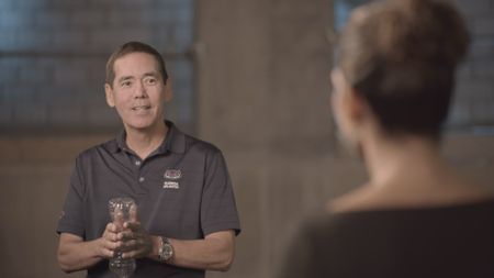 Dr. Stephen Kajiura demonstrating to Dr. Diva Amon how the sound of a plastic bottle being crinkled attracts sharks, while in the shark 360 studio lab. (National Geographic)