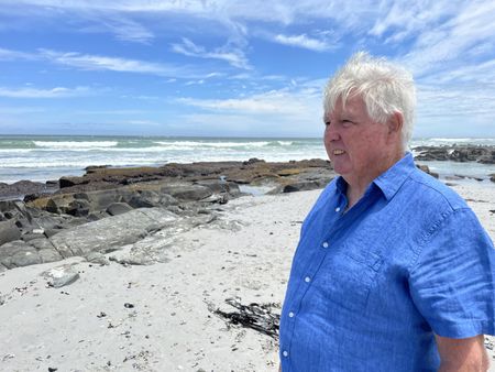 Charles Maxwell on the beach. (National Geographic/Robert Cowling)