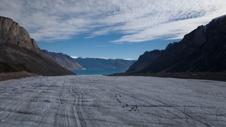 Alex Honnold and his team descend the Renland Icecap towards the Nordvestfjord in Eastern Greenland.  (photo credit: National Geographic/Pablo Durana)