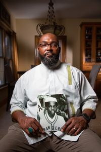 Tariq el-Amin, Imam of Masjid Al-Taqwa mosque in Chicago, IL, holds a photo of his cousin, Kaif Bismillah (birth name Keith Lavell Bibbs). (National Geographic/Tom Beard)