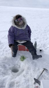 Teresa Pingayak ice fishing. (National Geographic/Matt Kynoch)