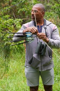 Christian Cooper erects a tall mist net at the Pu'u Maka'ala Natural Area Reserve. (National Geographic for Disney/Troy Christopher)