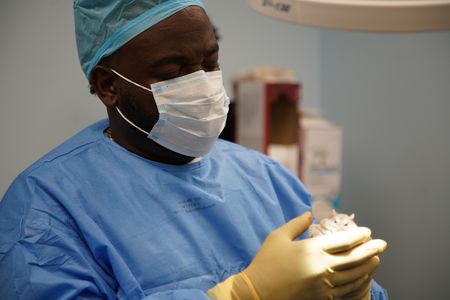 Dr. Hodges performs a tricky surgery on Coco, the dwarf hamster. (National Geographic for Disney/Sean Grevencamp)