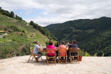 Guests gather around the table at the final cook. (National Geographic/Justin Mandel)