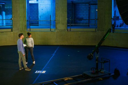 Diva Amon and director Martin Cass preparing for Diva's next scene in the lab. (National Geographic/Aubrey Fagon)