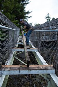 Matt Carlson helps repair a gangway. (National Geographic/Wes Waters)