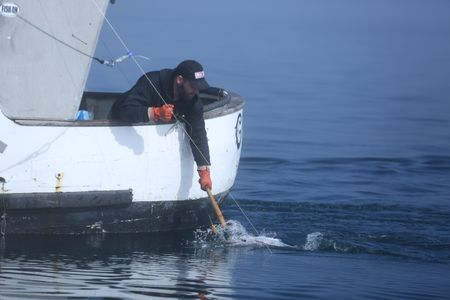 Matt Carlson fishes for salmon near the end of the summer troll season. (National Geographic/Wayne Moss)