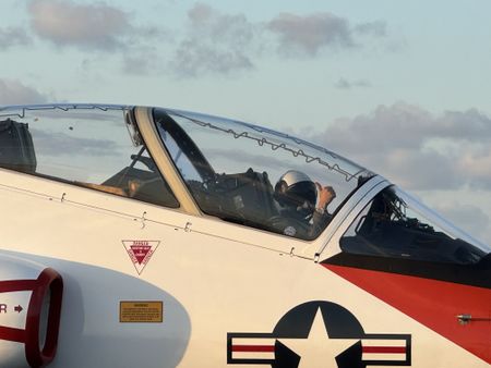 A pilot gives us a thumbs up from the front seat of a T-45. (Credit: National Geographic/Freddie Claire)