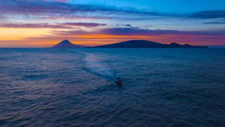 The crew rib returning to base at sunset. (credit: National Geographic/Bertie Gregory)