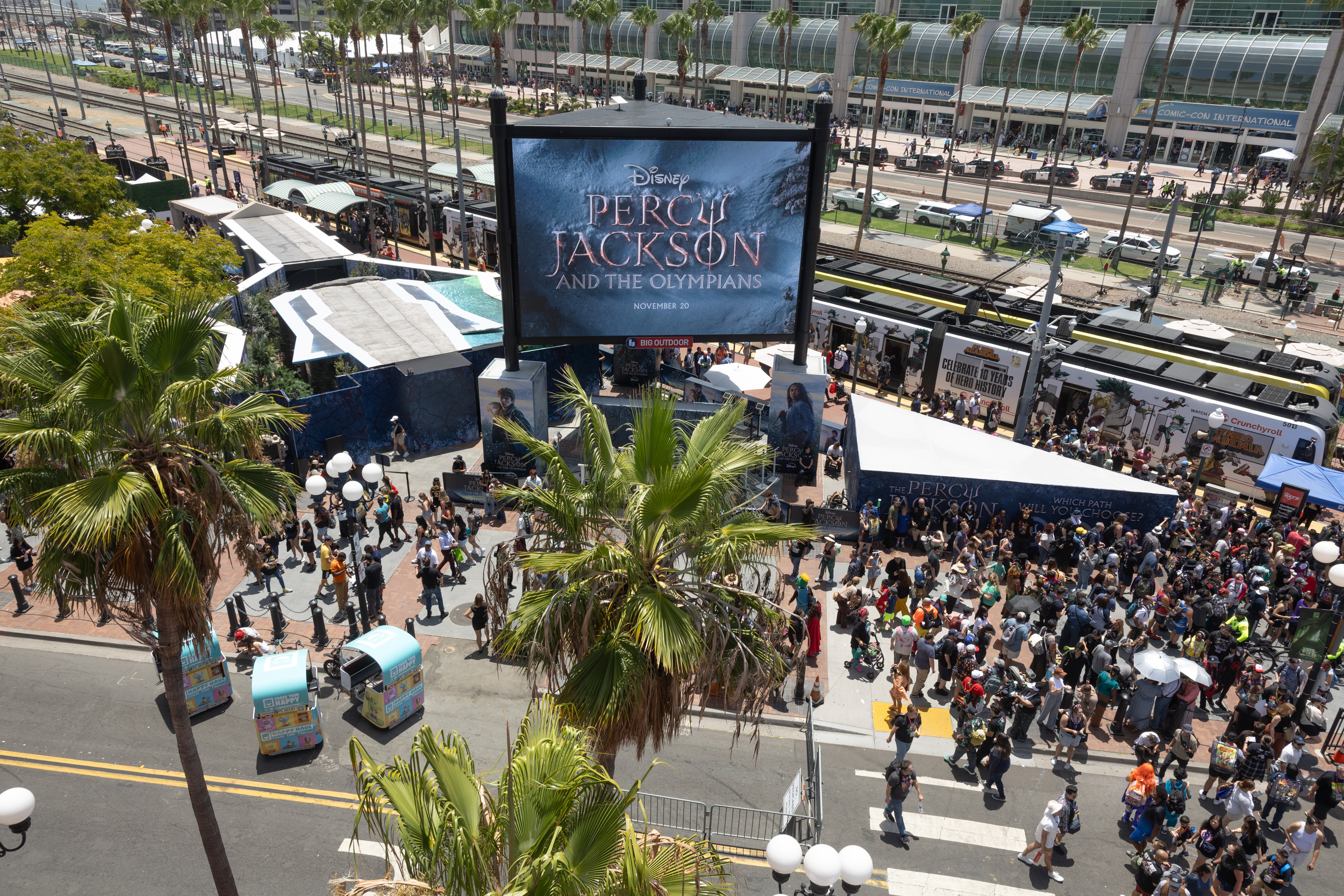 Percy Jackson and the Olympians Comic-Con 2026 activation photo – cast members in front of branded wall