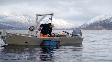Marvin Agnot collects his crab pots off his boat. (National Geographic)