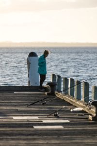 Storyteller and cephalopod expert, Dr Alex Schnell on a pier in Port Phillip Bay.  (photo credit: National Geographic/Harriet Spark)