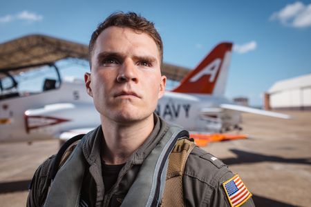 Student LTJG Dylan Horan poses next to a T-45. (National Geographic/Freddie Claire)