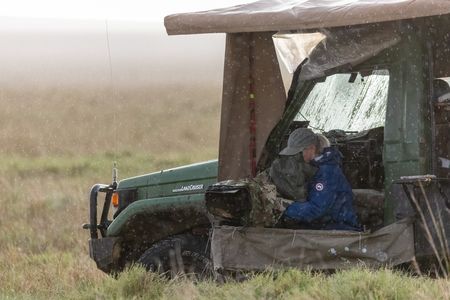 Director of Photography Sophie Darlington films as rain lashes down around her. (National Geographic/Simon Blakeney)