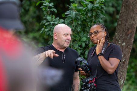 Russell Emanuel, Score Producer, Bleeding Fingers, and Faith Musembi chat while Russell records the Maasai singing. (National Geographic/Jane Atkins)