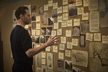 Tom Hiddleston examines a pinboard with clues as to how the events at Pompeii unfolded after the eruption of Mt. Vesuvius. (National Geographic/Christian Black)