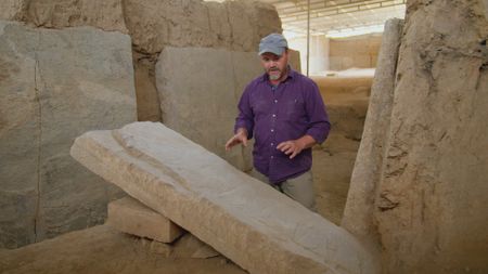 Dr. Michael Danti examines the stone reliefs of the Assyrians in Nineveh, Iraq. (Windfall Films)