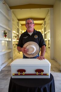 Coroner Scott McCord reflects on the casket containing Adam Doe's remains, which he had interred at his local mausoleum after seven years of trying unsuccessfully to find his family. (National Geographic/Tom Beard)