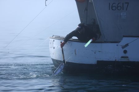 Matt Carlson fishes for salmon near the end of the summer troll season. (National Geographic/Wayne Moss)