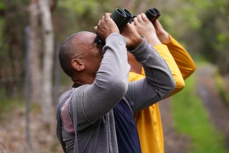 Christian Cooper and Bret Nainoa Mossman look for rare forest birds at the Pu'u Maka'ala Natural Area Reserve. (National Geographic for Disney/Troy Christopher)