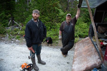 Oliver Johnson prepares to get a lesson in logging from Tim "Curly" Leach. (National Geographic/Lukas Taylor)