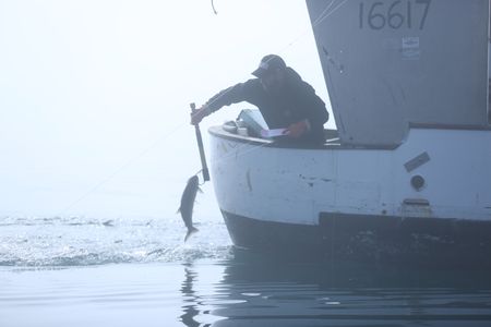 Matt Carlson fishes for salmon near the end of the summer troll season. (National Geographic/Wayne Moss)