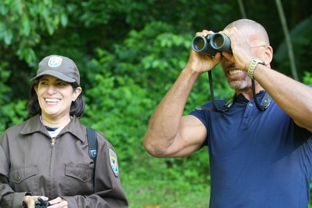 Christian Cooper observes the historic release of 7 Puerto Rican Parrots into the wild with Marisel López-Flores Lopez, the Project Leader of the Puerto Rican Parrot Recovery Program. (National Geographic for Disney)